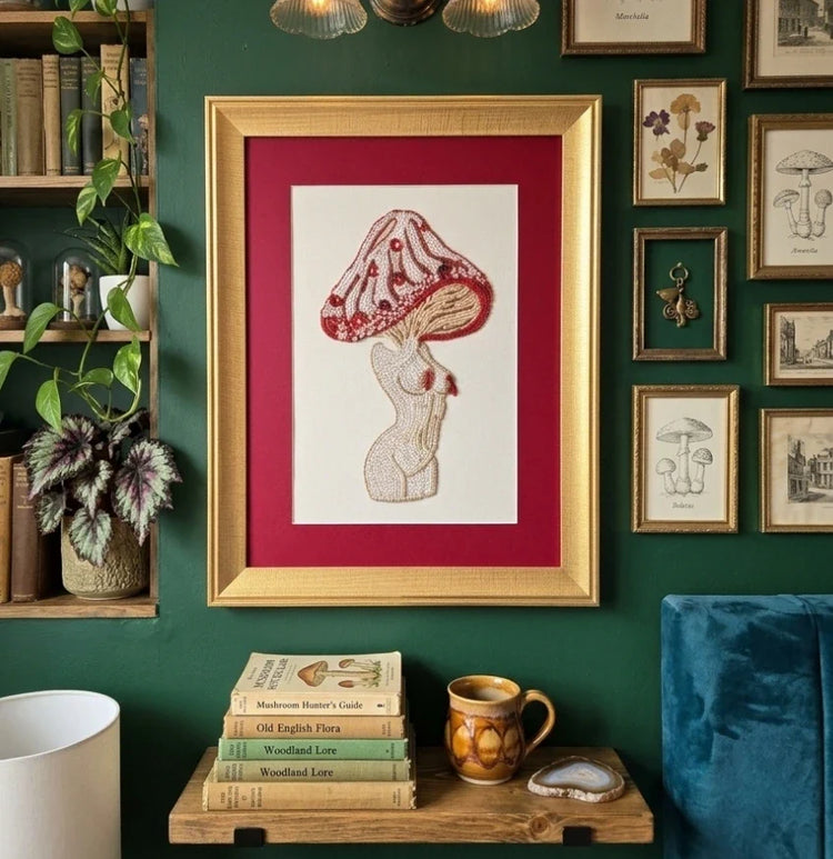Handcrafted embroidery wall art on a hoop being stitched in a studio setting.