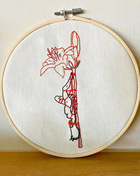 Our fiber art hoop is more than just a stitch. It’s a moment of surrender captured with actual shibari friction ties. Crafted for those who love the contrast of delicate beauty and sweet, tight control. Your walls called; they want some of this.
